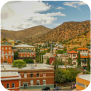 A scenic view of a town with a towering mountain in the background