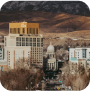 A vibrant city skyline with majestic mountains rising in the background